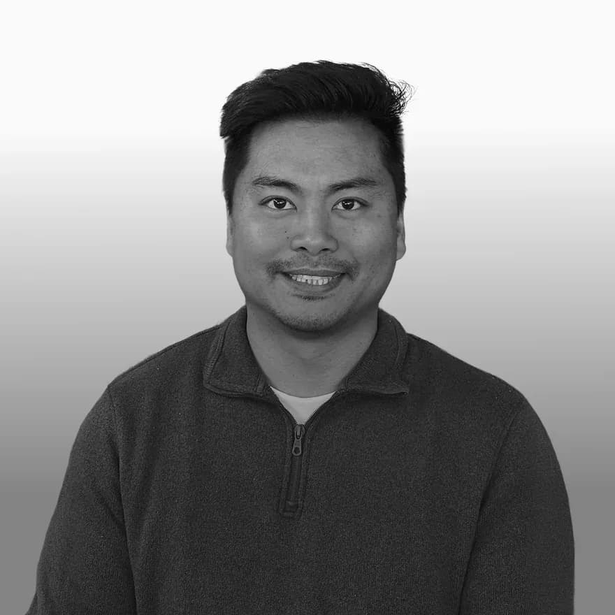 Black-and-white portrait of FTL Senior Engineer John Lugtu, an energy management and building systems specialist focused on transforming connected device data into actionable insights for commercial facilities.